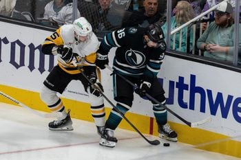 Oct 18, 2025; San Jose, California, USA; San Jose Sharks center Philipp Kurashev (96) and Pittsburgh Penguins defenseman Ryan Shea (5) battle for the puck behind the net during the third period at SAP Center at San Jose. Mandatory Credit: Neville E. Guard-Imagn Images
