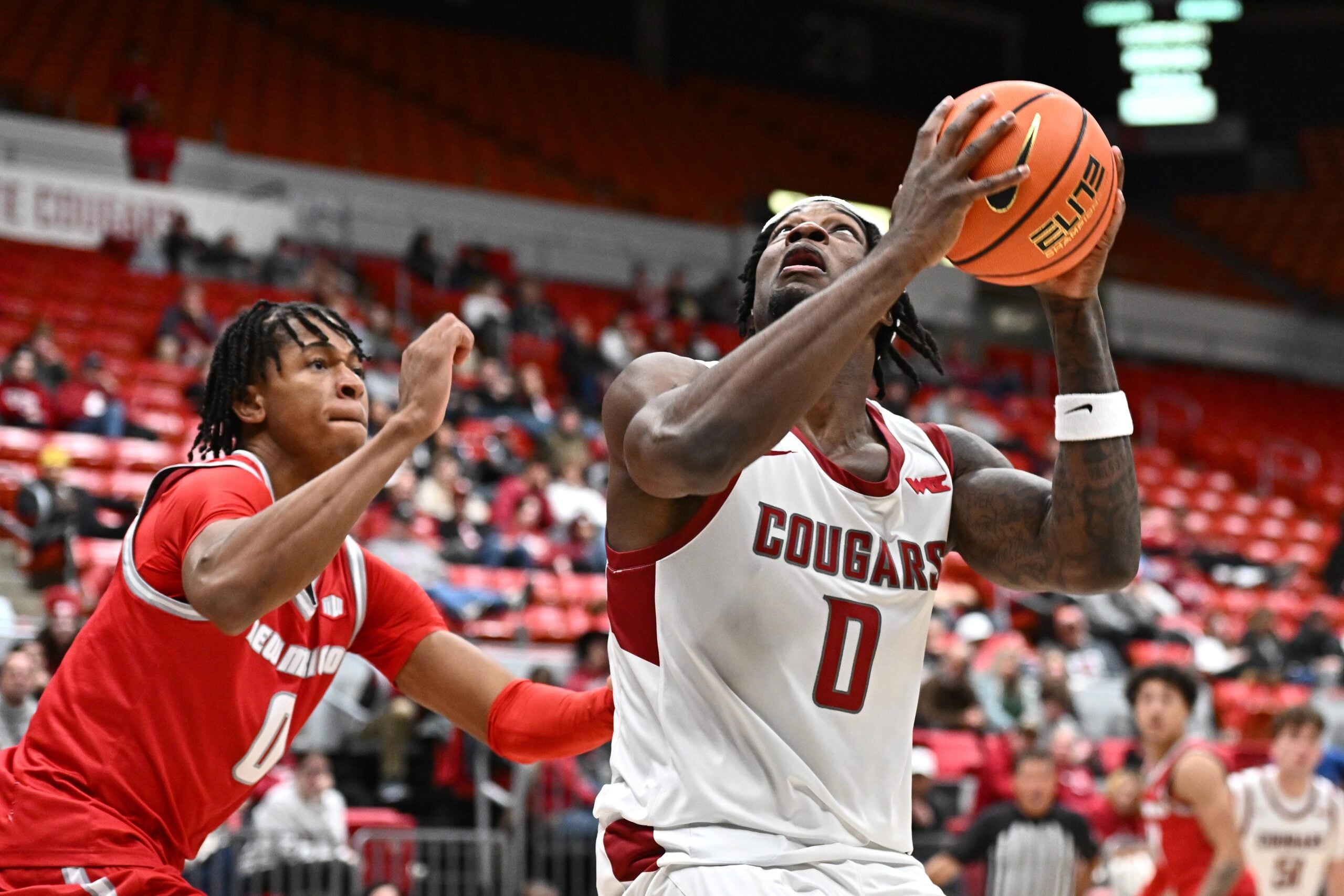 Oct 25, 2025; Pullman, WA, USA; Washington State Cougars forward Emmanuel Ugbo (0) shoots the ball against New Mexico Lobos guard Kevin Patton Jr. (0) in the second half at Friel Court at Beasley Coliseum. Mandatory Credit: James Snook-Imagn Images