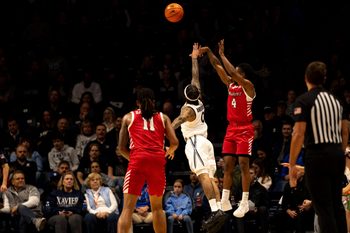 Marist Red Foxes guard Rhyjon Blackwell (4) hits a 3-point shot over Xavier Musketeers guard Roddie Anderson III (0) in the first half of the basketball game at the Cintas Center on Nov. 3, 2025.