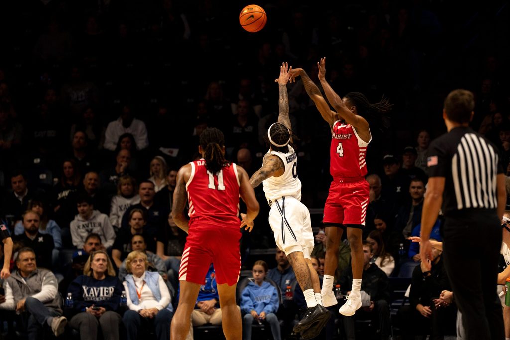 Marist Red Foxes guard Rhyjon Blackwell (4) hits a 3-point shot over Xavier Musketeers guard Roddie Anderson III (0) in the first half of the basketball game at the Cintas Center on Nov. 3, 2025.