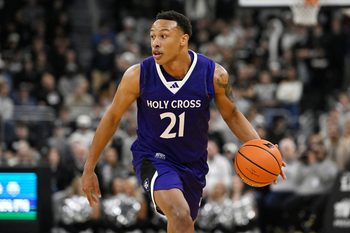 Nov 3, 2025; Providence, Rhode Island, USA; Holy Cross Crusaders guard Gabe Warren (21) dribbles the ball during the second half against the Providence Friars at Amica Mutual Pavilion. Mandatory Credit: Eric Canha-Imagn Images