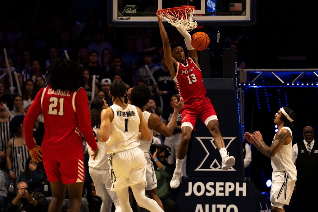 Marist Red Foxes guard Elijah Lewis (13) dunks as Marist Red Foxes guard Jadin Collins-Roberts (0) looks on in the second half of the basketball game at the Cintas Center on Nov. 3, 2025.