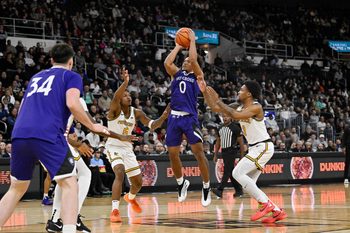 Nov 3, 2025; Providence, Rhode Island, USA; Holy Cross Crusaders guard Tyler Boston (0) shoots over the defense of Providence Friars forward Jamier Jones (5) and guard Daquan Davis (3) during the second half at Amica Mutual Pavilion. Mandatory Credit: Eric Canha-Imagn Images