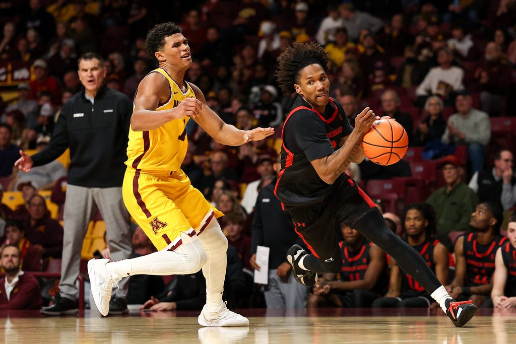 Nov 3, 2025; Minneapolis, Minnesota, USA; Gardner-Webb Runnin' Bulldogs guard Jacob Hudson (6) works around Minnesota Golden Gophers guard Isaac Asuma (1) during the second half at Williams Arena. Mandatory Credit: Matt Krohn-Imagn Images