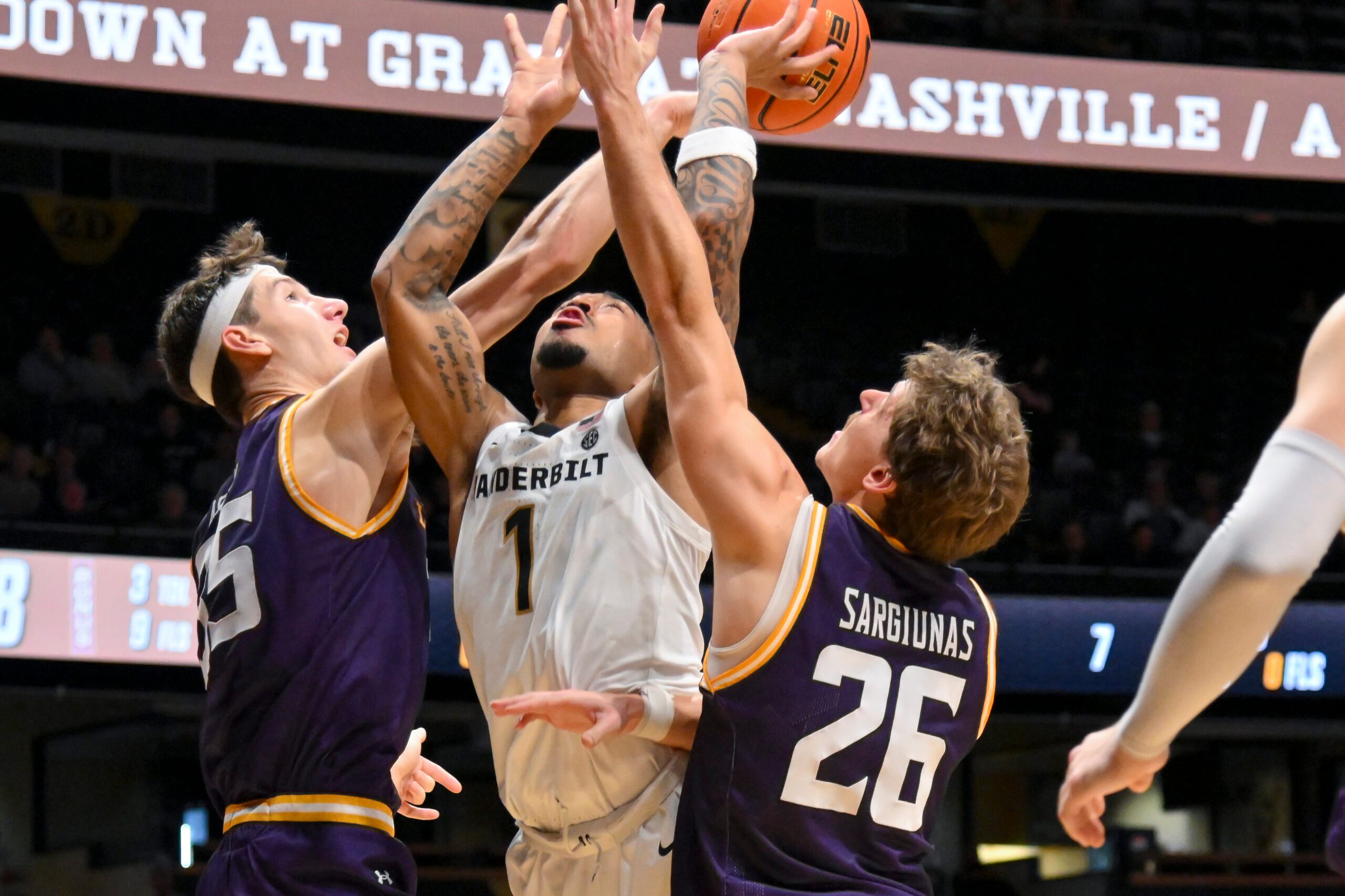 Nov 3, 2025; Nashville, Tennessee, USA;  Lipscomb Bisons center Grant Asman (35) blocks the shot of  Vanderbilt Commodores guard Frankie Collins (1) during the second half at Memorial Gymnasium. Mandatory Credit: Steve Roberts-Imagn Images