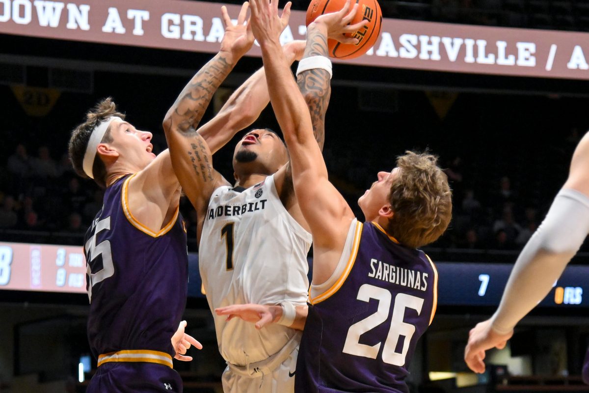 Nov 3, 2025; Nashville, Tennessee, USA; Lipscomb Bisons center Grant Asman (35) blocks the shot of Vanderbilt Commodores guard Frankie Collins (1) during the second half at Memorial Gymnasium. Mandatory Credit: Steve Roberts-Imagn Images