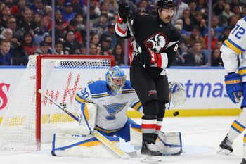 Nov 6, 2025; Buffalo, New York, USA;  Buffalo Sabres right wing Alex Tuch (89) tries to screen St. Louis Blues goaltender Joel Hofer (30) as he looks to make a save during the second period at KeyBank Center. Mandatory Credit: Timothy T. Ludwig-Imagn Images