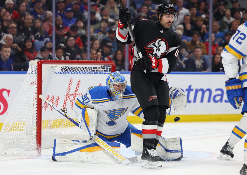 Nov 6, 2025; Buffalo, New York, USA; Buffalo Sabres right wing Alex Tuch (89) tries to screen St. Louis Blues goaltender Joel Hofer (30) as he looks to make a save during the second period at KeyBank Center. Mandatory Credit: Timothy T. Ludwig-Imagn Images