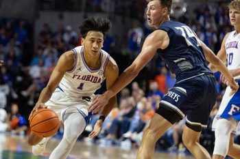 Florida guard Xaivian Lee (1) drives against North Florida forward Nestor Dyachok (24) during the second half of an NCAA basketball game at Steven C. O'Connel Center Exactech Areana in Gainesville, FL on Thursday, November 6, 2025. [Alan Youngblood/Gainesville Sun]