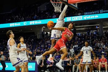 Nov 7, 2025; Evanston, Illinois, USA; Boston University Terriers guard Michael McNair (20) shoots the ball against Northwestern Wildcats forward Arrinten Page (22) (obscured) during the second half at Welsh-Ryan Arena. Mandatory Credit: David Banks-Imagn Images