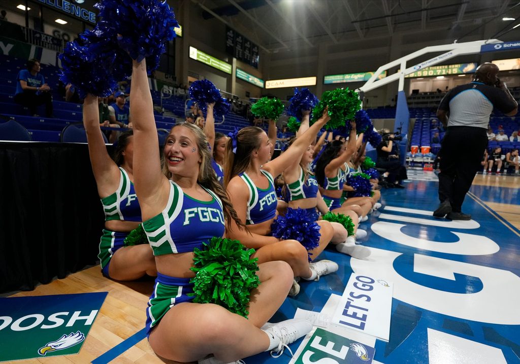 Cheerleader wav to the crowd. The Florida Gulf Coast University women's basketball team opened their season Saturday, Nov. 8, as the lady Eagles faced off against Davidson College Wildcats at Alico Arena. Davidson walked away with the victory with a final score of 77-51.