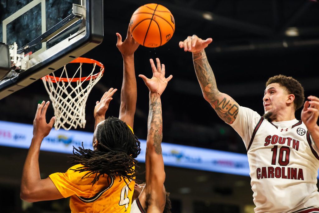 Nov 9, 2025; Columbia, South Carolina, USA; South Carolina Gamecocks forward Myles Stute (10) blocks the shot of Southern Mississippi Golden Eagles forward Tylik Weeks (4) in the second half at Colonial Life Arena. Mandatory Credit: Jeff Blake-Imagn Images