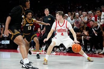 Ohio State Buckeyes guard Gabe Cupps (4) dribbles between Appalachian State Mountaineers center Luke Wilson (3) and guard Kasen Jennings (13) during the NCAA men's basketball game at Value City Arena in Columbus on Nov. 11, 2025.