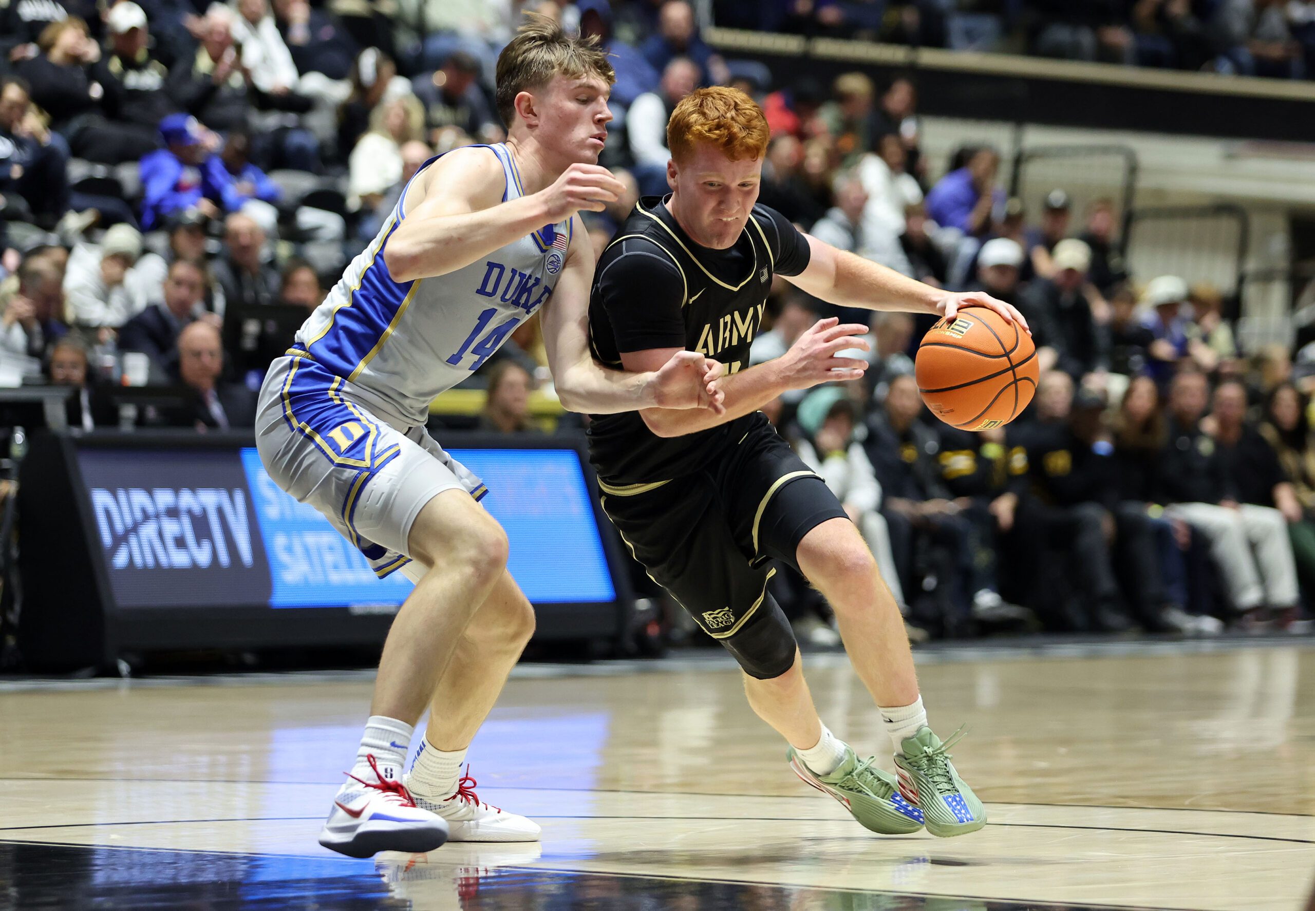 Nov 11, 2025; West Point, New York, USA; Army Black Knights guard Ryan Curry (2) is defended by Duke Blue Devils guard/forward Nikolas Khamenia (14) during the first half at Christl Arena. Mandatory Credit: Danny Wild-Imagn Images