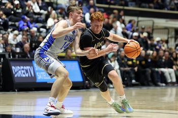 Nov 11, 2025; West Point, New York, USA; Army Black Knights guard Ryan Curry (2) is defended by Duke Blue Devils guard/forward Nikolas Khamenia (14) during the first half at Christl Arena. Mandatory Credit: Danny Wild-Imagn Images