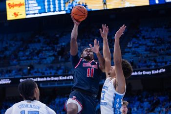 Nov 11, 2025; Chapel Hill, North Carolina, USA; Radford Highlanders guard Jr. Dennis Parker (11) shoots on North Carolina Tar Heels guard Derek Dixon (3) during the first half at Dean E. Smith Center. Mandatory Credit: Scott Kinser-Imagn Images