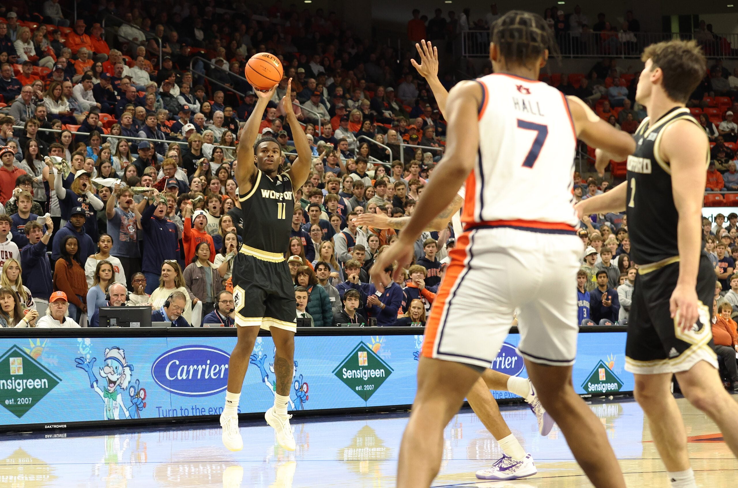 Nov 11, 2025; Auburn, Alabama, USA;  Wofford Terriers guard Kahmare Holmes (11) takes a 3-point shot during the first half against the Auburn Tigers at Neville Arena. Mandatory Credit: John Reed-Imagn Images