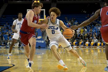 Nov 10, 2025; Los Angeles, California, USA;  UCLA Bruins guard Trent Perry (0) is defended by West Georgia Wolves guard Brady Hardewig (1) during the second half at Pauley Pavilion presented by Wescom Financial. Mandatory Credit: Jayne Kamin-Oncea-Imagn Images
