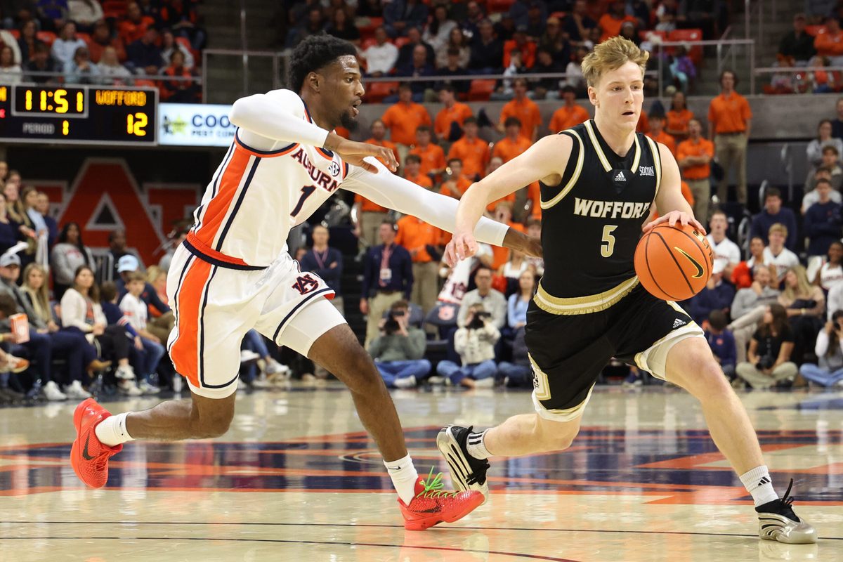 Nov 11, 2025; Auburn, Alabama, USA;  Wofford Terriers guard Brendan Rigsbee (5) runs a play as Auburn Tigers guard Kevin Overton (1) defends during the first half at Neville Arena. Mandatory Credit: John Reed-Imagn Images