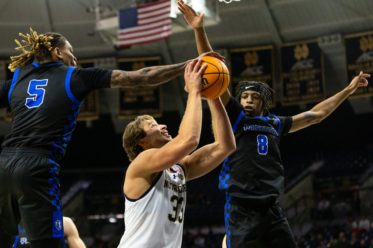 Nov 11, 2025; South Bend, Indiana, USA; Eastern Illinois Panthers guard Zion Fruster (5) blocks Notre Dame Fighting Irish forward Carson Towt (33) as forward Terry McMorris (8) also defends during the second half at Purcell Pavilion at the Joyce Center. Mandatory Credit: Michael Caterina-Imagn Images