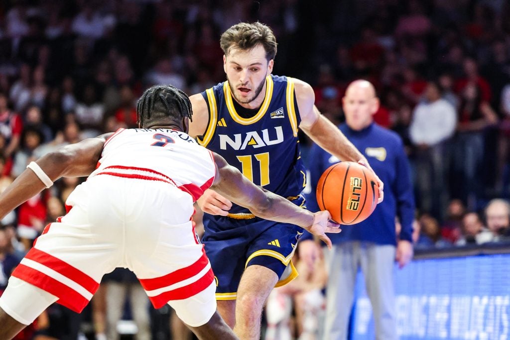 Nov 11, 2025; Tucson, Arizona, USA; Arizona Wildcats guard Dwayne Aristode (2) hits the ball out of the hand of Northern Arizona Lumberjacks guard Ryan Abelman (11) during the first half of the game at McKale Memorial Center. Mandatory Credit: Aryanna Frank-Imagn Images