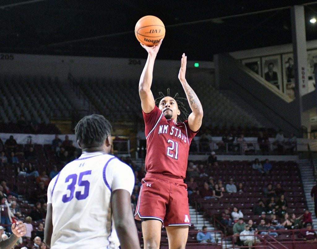 Jemel Jones takes a wide open shot as the Aggies took on the Cowboys of NM Highlands on Tuesday night at the Pan American Center.