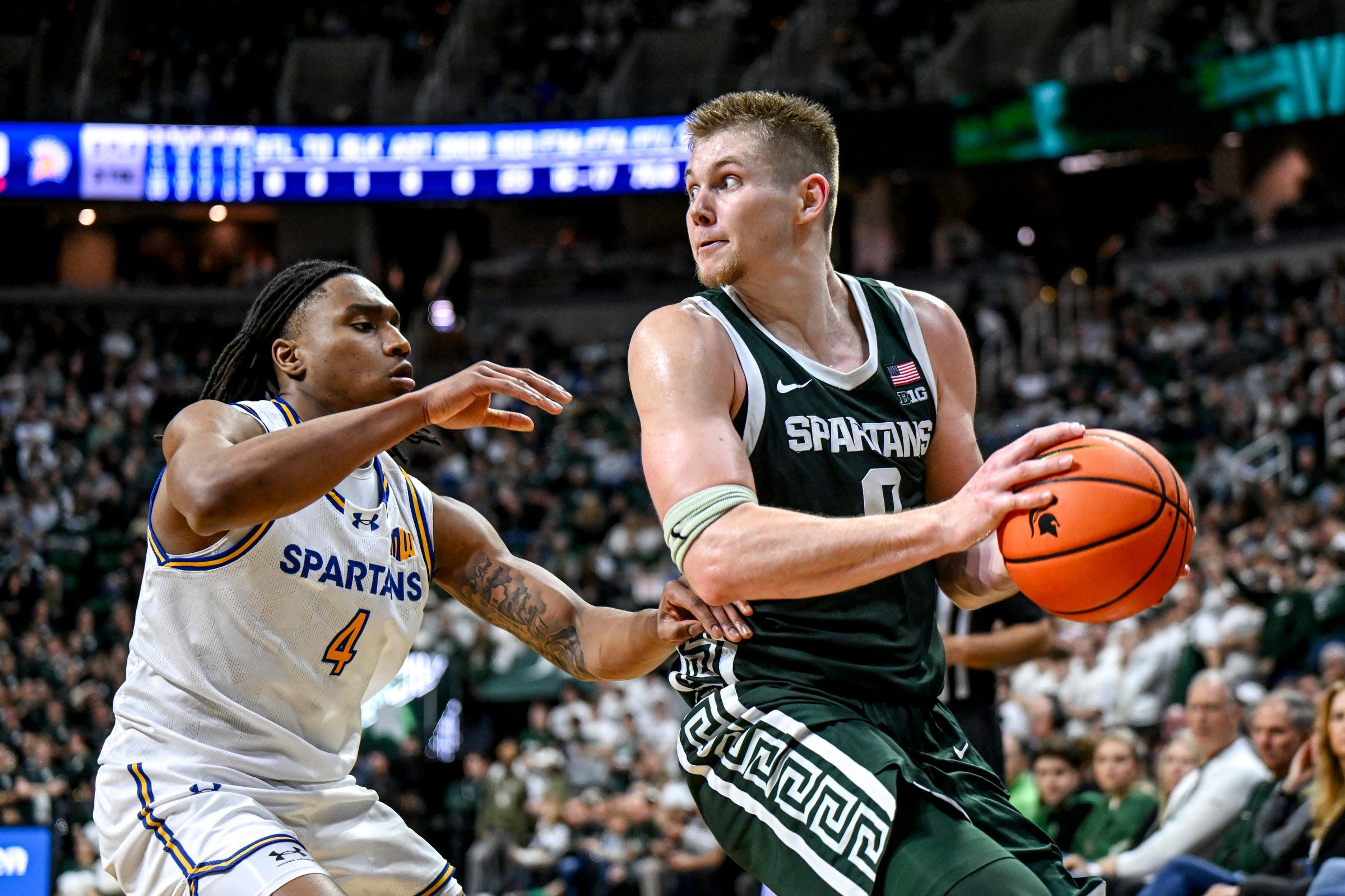 Michigan State's Jaxon Kohler, right, looks to pass as San Jose State's Melvin Bell Jr. defends during the second half on Thursday, Nov. 13, 2025, at the Breslin Center in East Lansing.