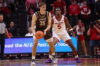 Nov 14, 2025; Piscataway, New Jersey, USA; Lehigh Mountain Hawks forward Hank Alvey (35) is guarded by Rutgers Scarlet Knights guard Darren Buchanan Jr. (5) during the second half at Jersey Mike's Arena. Mandatory Credit: Vincent Carchietta-Imagn Images