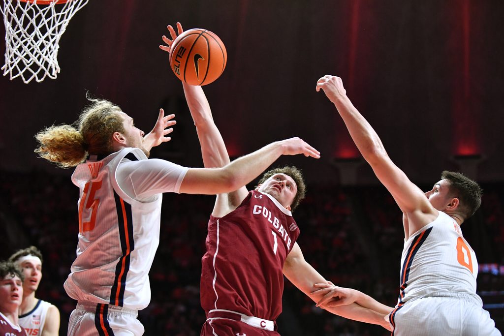 Nov 14, 2025; Champaign, Illinois, USA; Colgate Raiders guard Brady Cummins (1) tries to pull down a rebound between Illinois Fighting Illini forward Jake Davis (15) and David Mirkovic (0)during the first half at State Farm Center. Mandatory Credit: Ron Johnson-Imagn Images