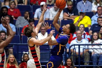 Nov 14, 2025; Oxford, Mississippi, USA; Cal State Bakersfield Roadrunners guard Dailin Smith (15) shoots as Mississippi Rebels guard Travis Perry (11) defends during the first half at C.M. ’Tad’ Smith Coliseum. Mandatory Credit: Petre Thomas-Imagn Images