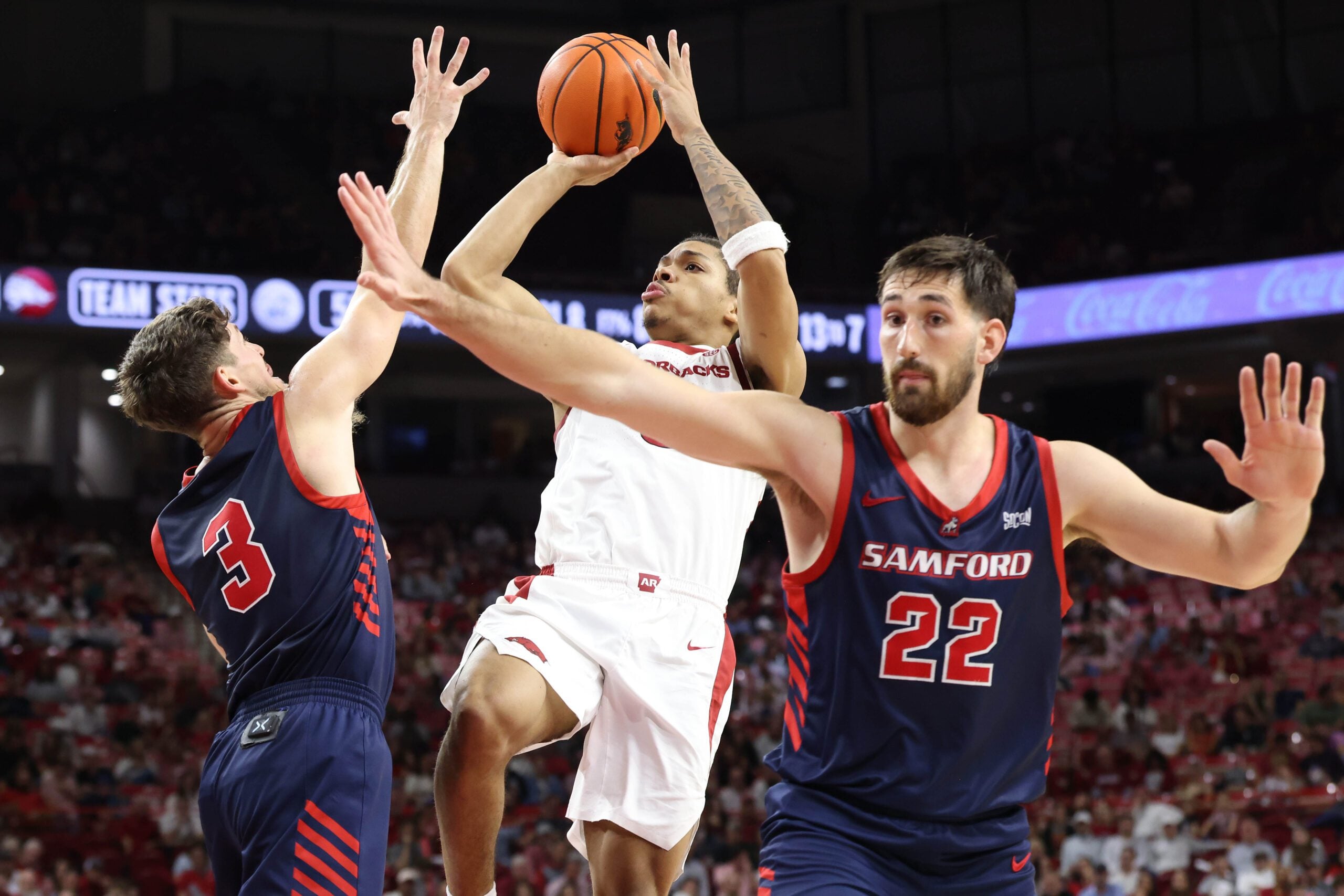Nov 14, 2025; Fayetteville, Arkansas, USA; Arkansas Razorbacks guard Darius Acuff Jr (5) shoots in the second half as Samford Bulldogs guard Keaton Norris (3) and forward Jaxon Pollard (22) defend at Bud Walton Arena. Arkansas won 79-75. Mandatory Credit: Nelson Chenault-Imagn Images
