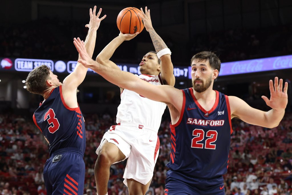 Nov 14, 2025; Fayetteville, Arkansas, USA; Arkansas Razorbacks guard Darius Acuff Jr (5) shoots in the second half as Samford Bulldogs guard Keaton Norris (3) and forward Jaxon Pollard (22) defend at Bud Walton Arena. Arkansas won 79-75. Mandatory Credit: Nelson Chenault-Imagn Images