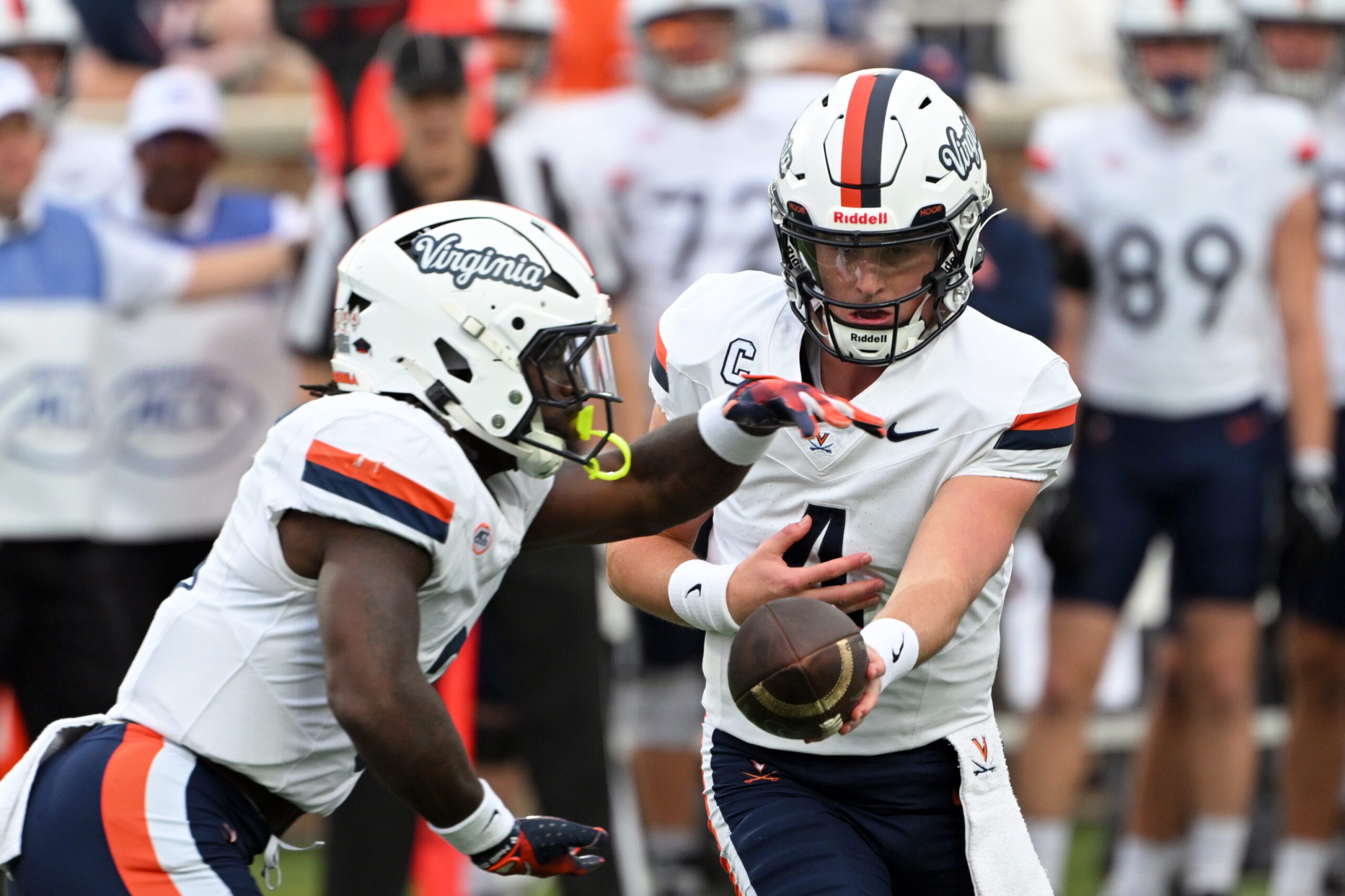 Nov 15, 2025; Durham, North Carolina, USA;  Virginia Cavaliers quarter back Chandler Morris (4) hands the ball to Virginia Cavaliers running back J'Mari Taylor (3) during the first quarter against the Duke Blue Devils at Wallace Wade Stadium. Mandatory Credit: Zachary Taft-Imagn Images