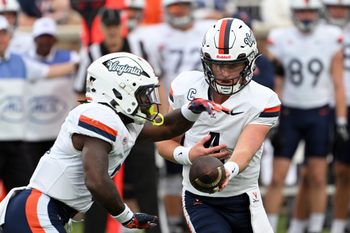 Nov 15, 2025; Durham, North Carolina, USA;  Virginia Cavaliers quarter back Chandler Morris (4) hands the ball to Virginia Cavaliers running back J'Mari Taylor (3) during the first quarter against the Duke Blue Devils at Wallace Wade Stadium. Mandatory Credit: Zachary Taft-Imagn Images