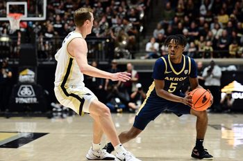 Nov 16, 2025; West Lafayette, Indiana, USA; Akron Zips guard Tavari Johnson (5) looks to get around Purdue Boilermakers guard Fletcher Loyer (2) during the first half at Mackey Arena. Mandatory Credit: Marc Lebryk-Imagn Images