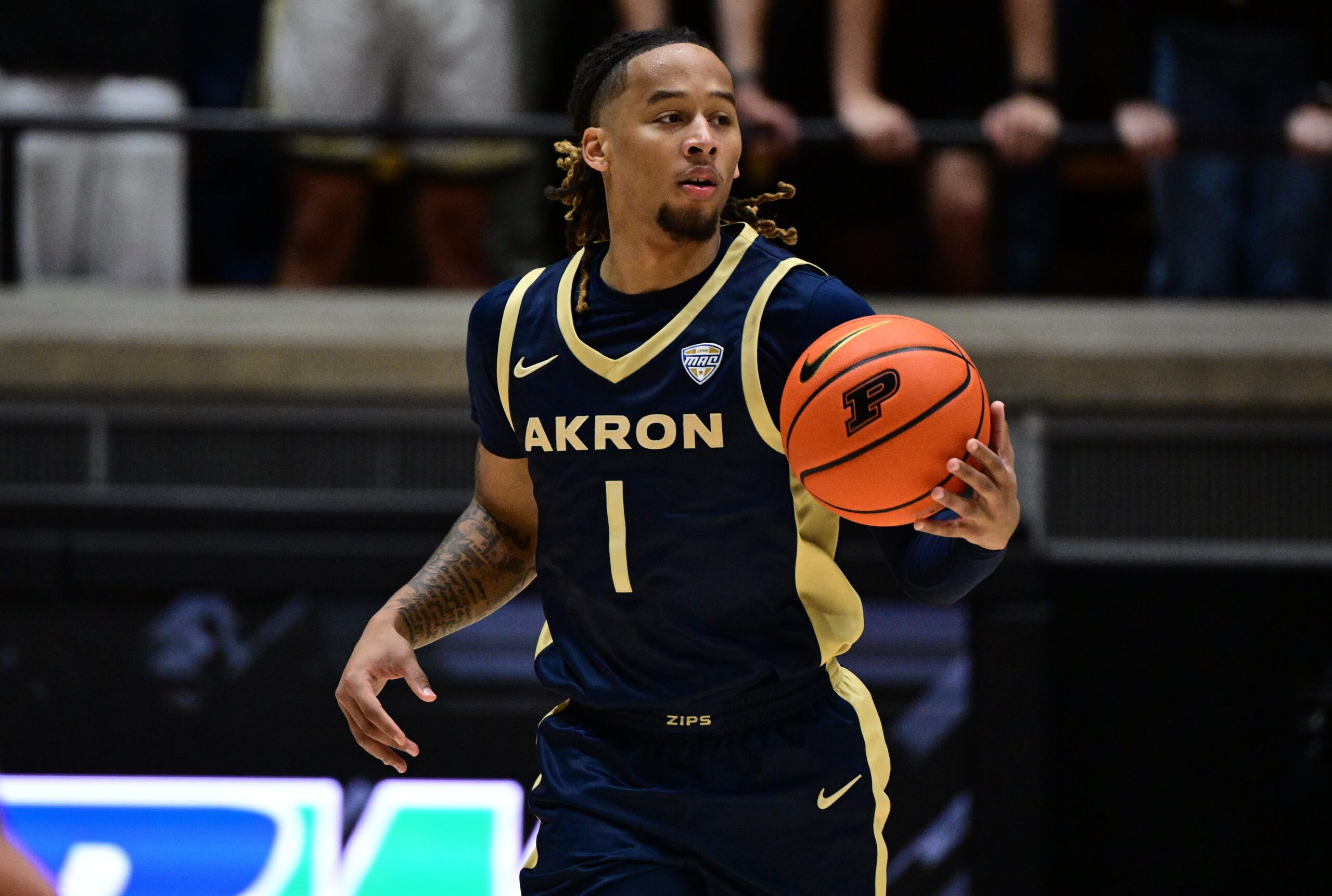 Nov 16, 2025; West Lafayette, Indiana, USA; Akron Zips guard Shammah Scott (1) dribbles down court during the first half against the Purdue Boilermakers at Mackey Arena. Mandatory Credit: Marc Lebryk-Imagn Images