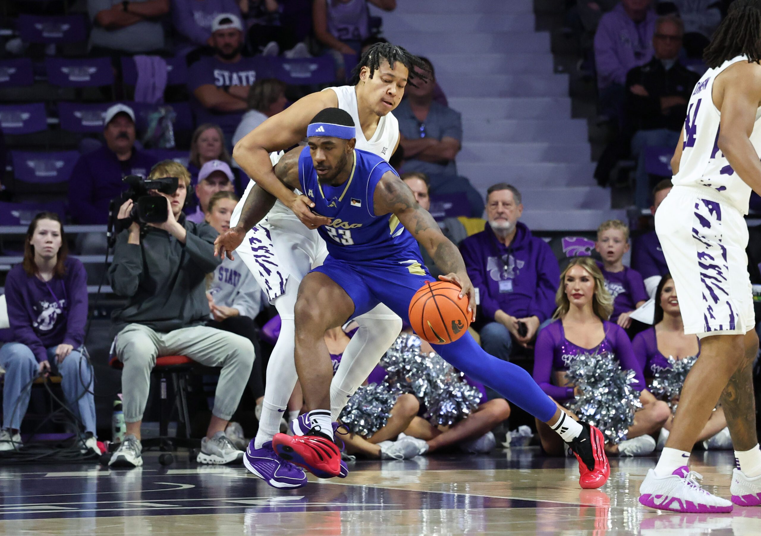 Nov 17, 2025; Manhattan, Kansas, USA; Tulsa Golden Hurricane forward David Green (23) is guarded by Kansas State Wildcats forward Elias Rapieque (0) during the first half at Bramlage Coliseum. Mandatory Credit: Scott Sewell-Imagn Images