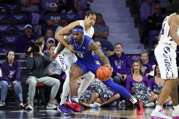 Nov 17, 2025; Manhattan, Kansas, USA; Tulsa Golden Hurricane forward David Green (23) is guarded by Kansas State Wildcats forward Elias Rapieque (0) during the first half at Bramlage Coliseum. Mandatory Credit: Scott Sewell-Imagn Images