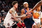 Nov 18, 2025; Columbia, South Carolina, USA; Radford Highlanders guard Dennis Parker (11) drives around South Carolina Gamecocks forward Myles Stute (10) in the second half at Colonial Life Arena. Mandatory Credit: Jeff Blake-Imagn Images