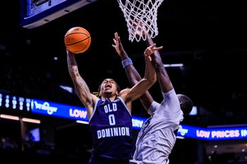 Nov 18, 2025; Cincinnati, Ohio, USA; Old Dominion Monarchs guard KC Shaw (0) shoots against Xavier Musketeers forward Pape N'Diaye (22) in the second half at Cintas Center. Mandatory Credit: Katie Stratman-Imagn Images