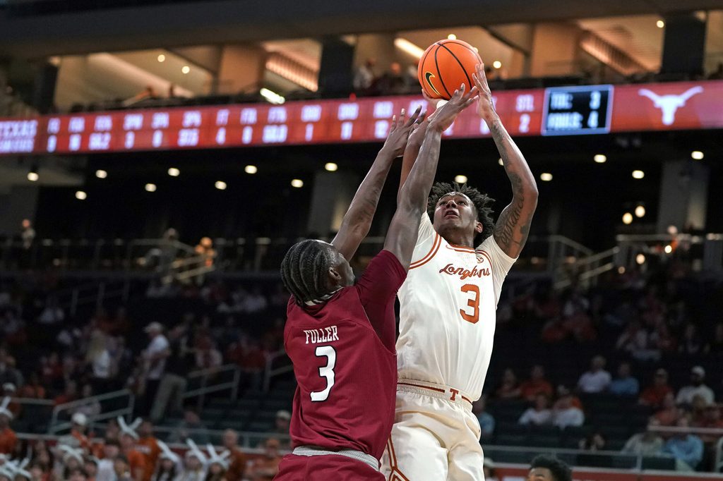 Nov 18, 2025; Austin, Texas, USA; Texas Longhorns guard Dailyn Swain (3) shoots against Rider Broncs forward Shemani Fuller (3) during the first half at Moody Center. Mandatory Credit: Dustin Safranek-Imagn Images