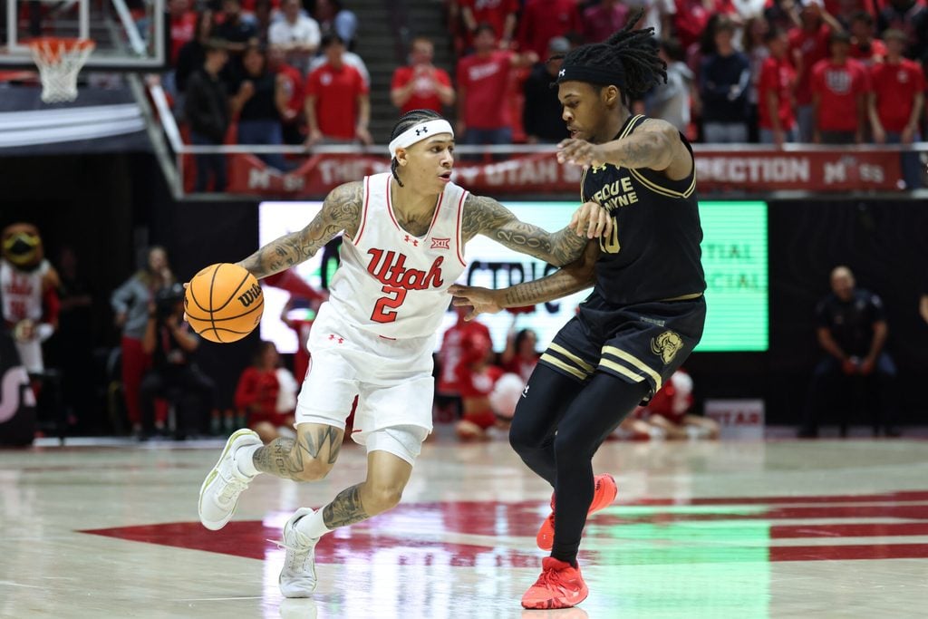 Nov 18, 2025; Salt Lake City, Utah, USA; Utah Utes guard Terrence Brown (2) dribbles against Purdue Fort Wayne Mastodons guard Corey Hadnot II (10) during the second half at Jon M. Huntsman Center. Mandatory Credit: Rob Gray-Imagn Images