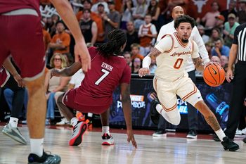 Nov 18, 2025; Austin, Texas, USA; Texas Longhorns guard Jordan Pope (0) drives the ball to the basket against Rider Broncs forward Davis Bynim (7) during the first half at Moody Center. Mandatory Credit: Dustin Safranek-Imagn Images