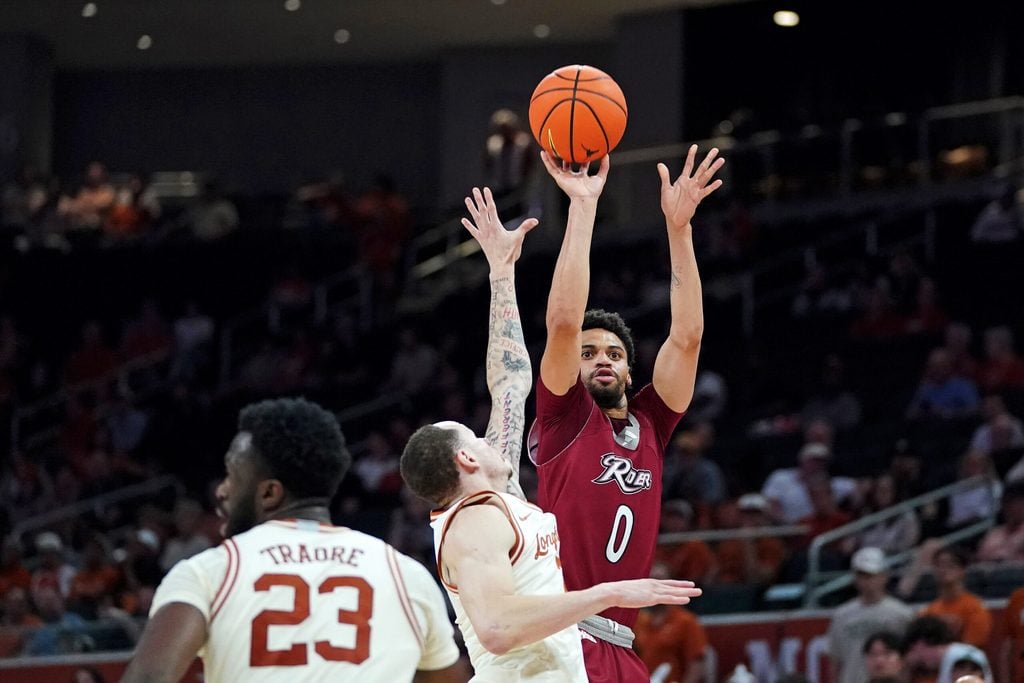 Nov 18, 2025; Austin, Texas, USA; Rider Broncs forward Zion Cruz (0) shoots a three point basket against Texas Longhorns guard Chendall Weaver (2) during the second half at Moody Center. Mandatory Credit: Dustin Safranek-Imagn Images