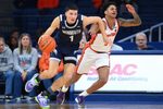 Nov 18, 2025; Syracuse, New York, USA; Monmouth Hawks forward Jason Rivera-Torres (1) drives against Syracuse Orange guard Kiyan Anthony (7) during the second half at the JMA Wireless Dome. Mandatory Credit: Rich Barnes-Imagn Images