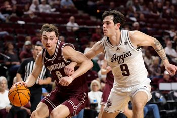 Nov 18, 2025; College Station, Texas, USA; Montana Grizzlies guard Tyler Isaak (8) drives as Texas A&M Aggies guard Ruben Dominguez (9) defends during the second half at Reed Arena. Mandatory Credit: Maria Lysaker-Imagn Images