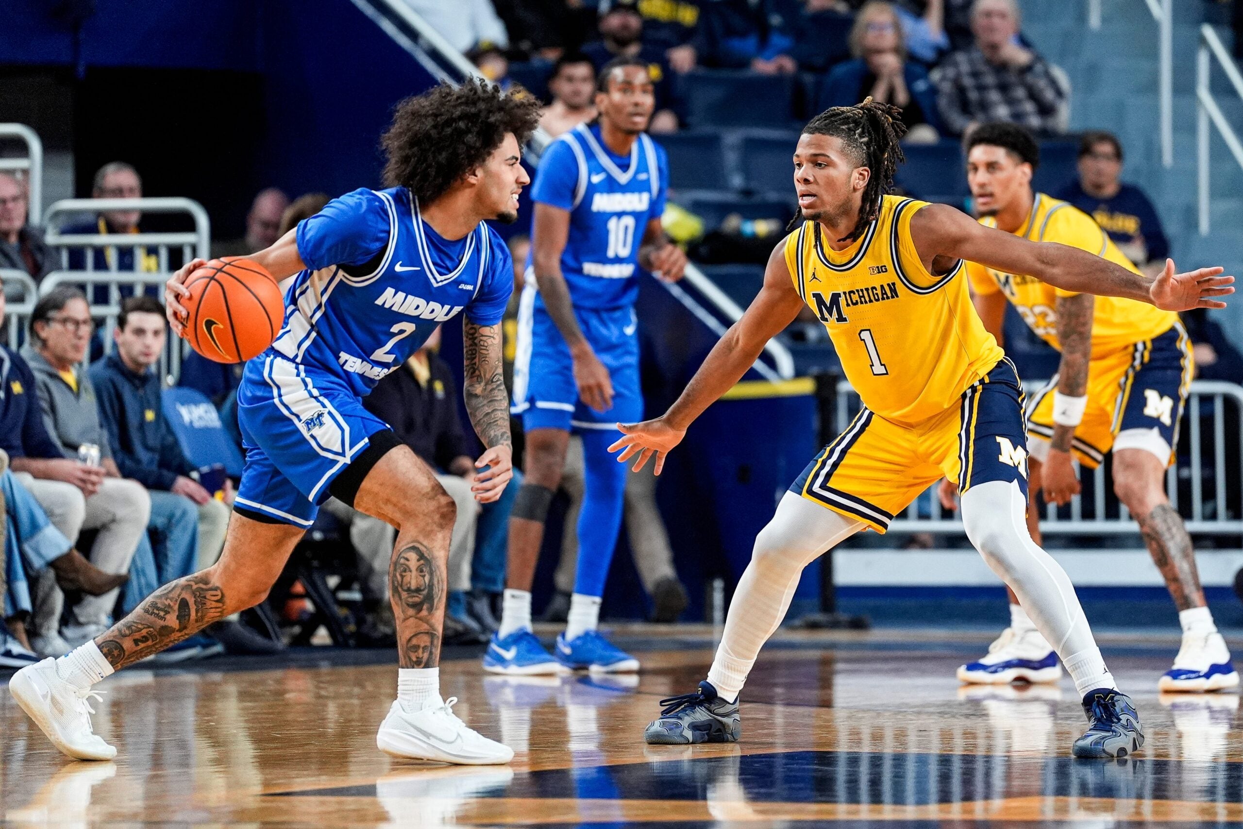 Michigan guard Trey McKenney (1) defends Middle Tennessee guard Jahvin Carter (2) during the first half at Crisler Center in Ann Arbor on Wednesday, November 19, 2025.