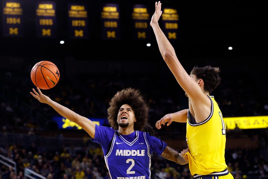 Nov 19, 2025; Ann Arbor, Michigan, USA; Middle Tennessee Blue Raiders guard Jahvin Carter (2) shoots defended by Michigan Wolverines center Aday Mara (15) in the second half at Crisler Center. Mandatory Credit: Rick Osentoski-Imagn Images