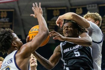 Nov 19, 2025; South Bend, Indiana, USA; Bellarmine Knights guard Myles Watkins (5) fights for a rebound against Notre Dame Fighting Irish guard Jalen Haralson, left, and forward Brady Koehler, right, during the second half at Purcell Pavilion at the Joyce Center. Mandatory Credit: Michael Caterina-Imagn Images