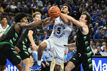 Nov 19, 2025; Omaha, Nebraska, USA;  North Dakota Fighting Hawks guard Greyson Uelmen (3) fouls Creighton Bluejays guard Nik Graves (5) on a shot attempt during the second half at CHI Health Center Omaha. Mandatory Credit: Steven Branscombe-Imagn Images